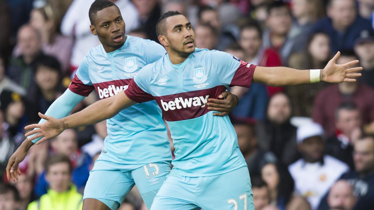 West Ham United's Dimitri Payet, right, celebrates with teammate Diafra Sakho after scoring during the English FA Cup quarterfinal soccer match between Manchester United and West Ham United at Old Trafford Stadium, Manchester, England, Sunday March 13, 2016. (AP Photo/Jon Super)