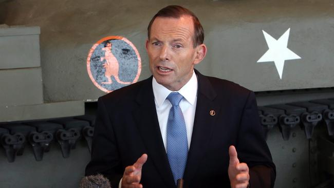 Tony Abbott talks to reporters at the Canadian War Museum in Ottawa.