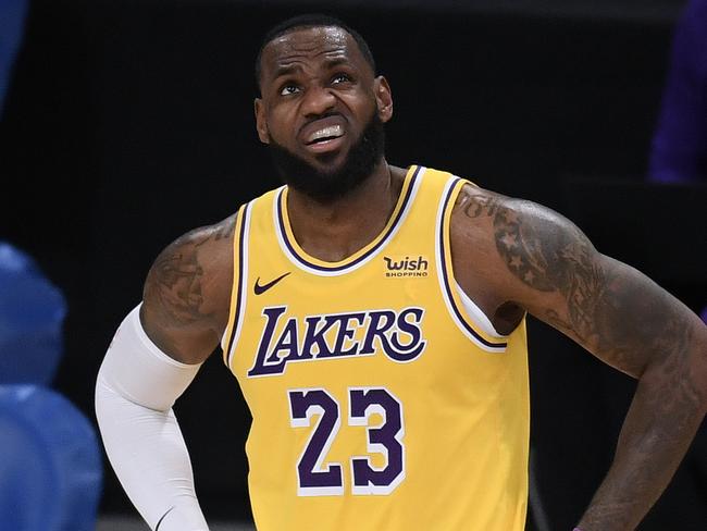 LOS ANGELES, CALIFORNIA - DECEMBER 22:  LeBron James #23 of the Los Angeles Lakers reacts as he looks up at a replay during a 116-109 LA Clippers win in the season opening game at Staples Center on December 22, 2020 in Los Angeles, California. NOTE TO USER: User expressly acknowledges and agrees that, by downloading and or using this photograph, User is consenting to the terms and conditions of the Getty Images License Agreement. (Photo by Harry How/Getty Images)