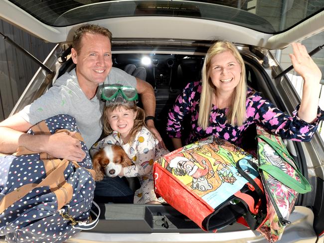 Mark and Andrea Jenson, their 3 year-old daughter Alexa and 9 year-old dog Penny load their car up for a weekend away in anticipation of the ring of steel to be lifted tomorrow. Picture: Andrew Henshaw