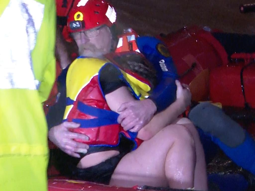 She was pulled into a boat, where she clung to her rescuer. Picture: TNV