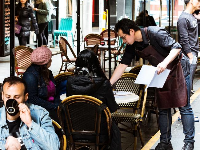 MELBOURNE, AUSTRALIA - JUNE 01: Cafes in Melbourne's Degraves street open for dine in customers on June 01, 2020 in Melbourne, Australia. Restrictions continue to ease around Australia in response to the country's declining COVID-19 infection rate. In New South Wales, beauty salons, tanning salons and nail bars can reopen from 1 June, along with museums, zoos and galleries while pubs, clubs, cafes and restaurants will also be able to serve up to 50 customers at a time. Traveling to regional NSW for a holiday will be allowed again. In Victoria, museums, zoos and galleries can reopen while restaurants, pubs and cafes can serve meals for up to 20 patrons. Beauty salons, spas and tattoo parlours can also open for up to 20 people. Gatherings of up 20 people in a home, overnight stays at private residences and tourist accommodations and greater numbers at weddings, funerals and religious ceremonies are also permitted as of 1 June 2020. Restrictions in South Australia also continue to ease from Monday June 1, with cinemas, theatres, galleries, museums, beauty salons, gyms and indoor fitness centres across the state able to reopen. Those venues, along with pubs, bars, restaurants and cafes, will be able to admit up to 80 patrons, provided they can contain them to groups of 20 or less. Any business opening to patrons must allow four square metres for every one person inside, and ensure 1.5-metre social distancing is observed. (Photo by Darrian Traynor/Getty Images)