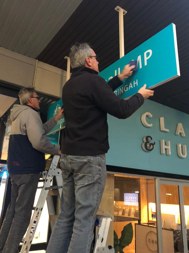 Grant Wiles and his brother Matt, from Absolute Sign Solutions at Brookvale, work to replace the Tony Abbott signs. Picture: Jim O’Rourke.