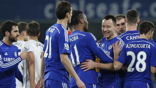 Chelsea's John Terry, second right, smiles as he embraces his teammates.