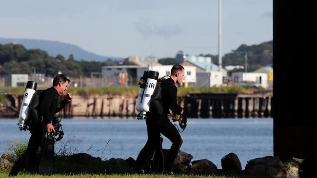 Police divers at the Port of Newcastle last week preparing to dive in around the ship and continue investigating. Picture: Peter Lorimer