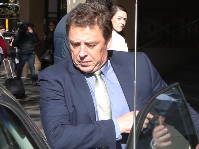 Former Essendon player and AFL coach Mark Thompson leaves the Melbourne Magistrate Court in Melbourne, Friday, May 25, 2018. AFL great Mark "Bomber" Thompson has dashed in and out of a Melbourne court, nearly avoiding cameras as his drug trafficking case was adjourned for a month. (AAP Image/David Crosling) NO ARCHIVING