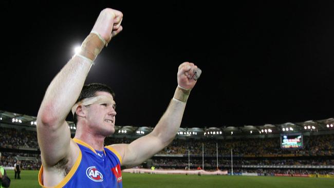 A battered Jonathan Brown celebrates just after the siren. Picture: Darren England