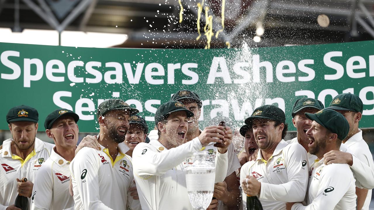 Tim Paine of Australia lifts the Urn