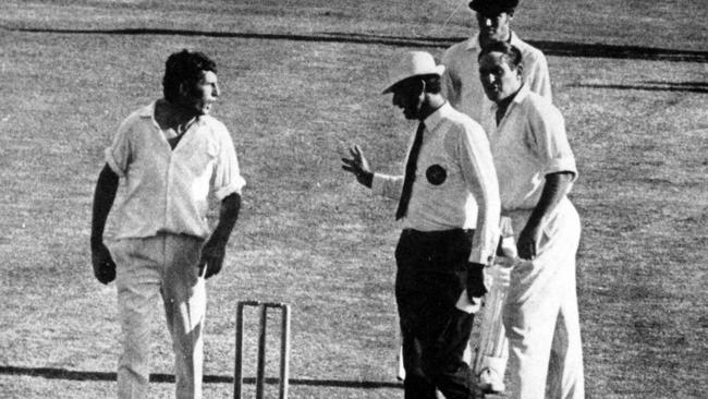 Umpire Lou Rowan argues with fast bowler John Snow and captain Ray Illingworth after an incident in which tail-end batsman Terry Jenner was assisted from field after being hit by bouncer.