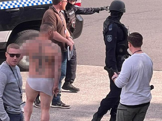 Exclusive image supplied to Mark Morri. Dillon Mancuso former Lone Wolf (in white undies) is the victim of the violent kidnapping which ended with 11 men being arrested, after a stand-off with police that lasted almost 12 hours. Incredible footage shows police raiding an industrial warehouse on Marigold Street at Revesby about 1pm.