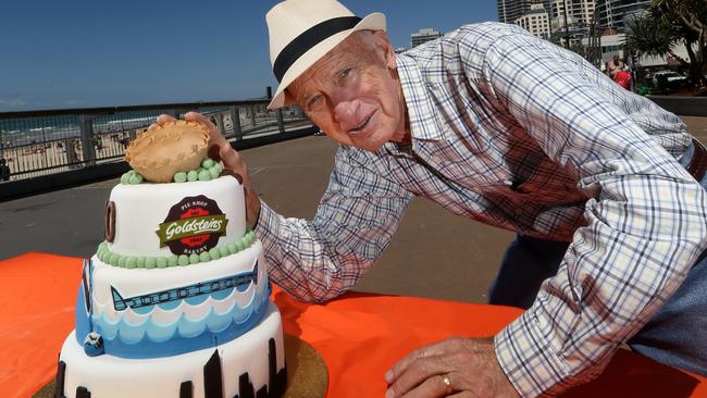 Frank Goldstein with a special cake made for the 70th year celebration of the business, at Surfers Paradise, Gold Coast.