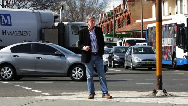 Harold Scruby standing on the median at Spit Junction. Picture: Virginia Young