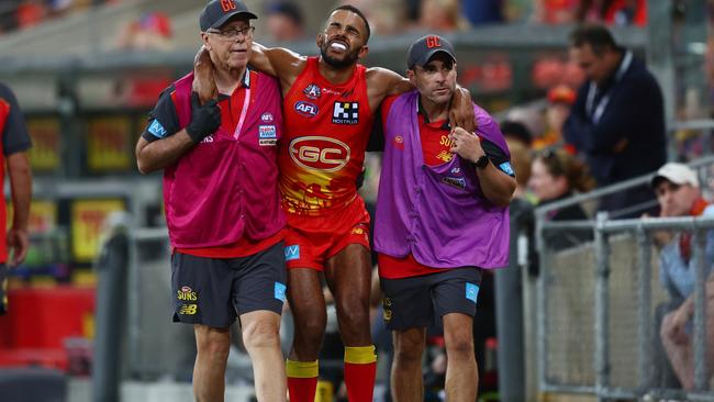 Touk Miller in the hands of the trainers. (Photo by Chris Hyde/Getty Images)