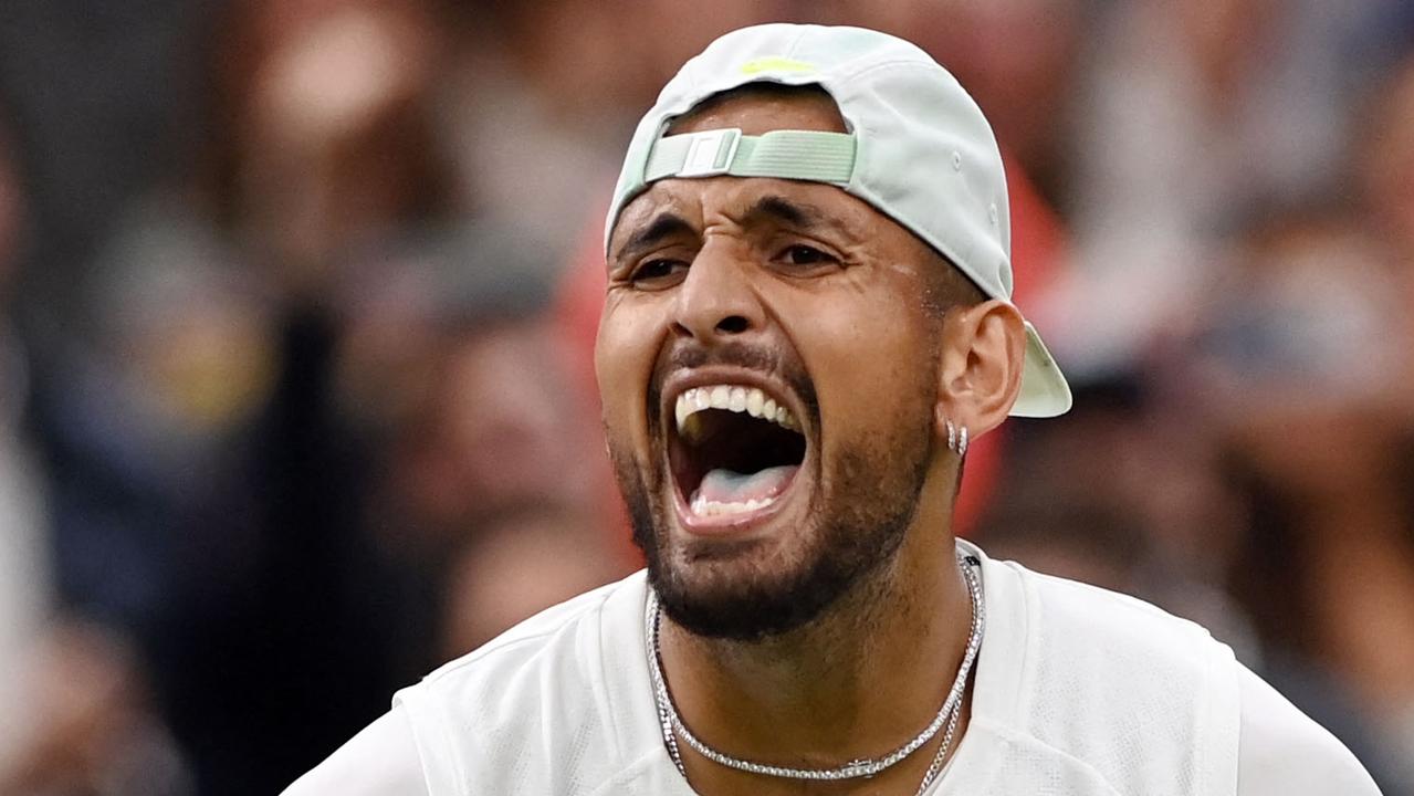 TOPSHOT - Australia's Nick Kyrgios celebrates beating Greece's Stefanos Tsitsipas during their men's singles tennis match on the sixth day of the 2022 Wimbledon Championships at The All England Tennis Club in Wimbledon, southwest London, on July 2, 2022. (Photo by Glyn KIRK / AFP) / RESTRICTED TO EDITORIAL USE