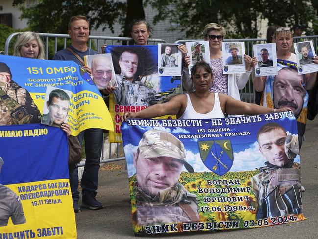 Family members of Ukrainian prisoners hold banners and photos of servicemen in captivity ahead of an exchange of prisoners between Russia and Ukraine, in Chernyhiv region, Ukraine. Picture: AP Photo