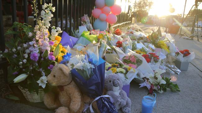 Flowers left at the front gate of the school. Picture: John Grainger