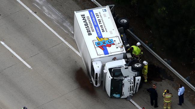 Two highway patrol police were almost killed when their patrol car was clipped by a truck, catapulting the stationary vehicle into a roadside barrier. Photo: David Clark