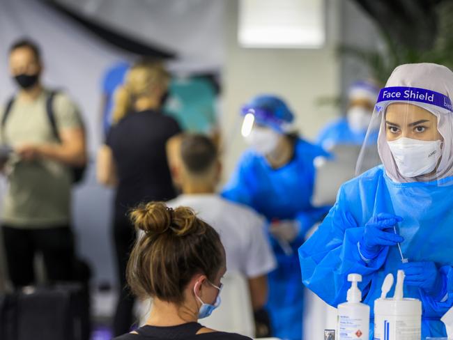 A health worker looks on at the Histopath pre-departure testing clinic at Sydney International airport. Demand at testing centres across Sydney has increased in the lead up to Christmas. Picture: Jenny Evans/Getty Images