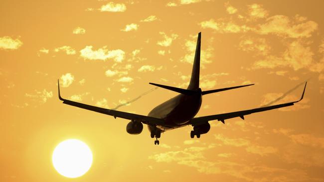 DRIP PRICING  ..  photo of a passenger plane at sunset