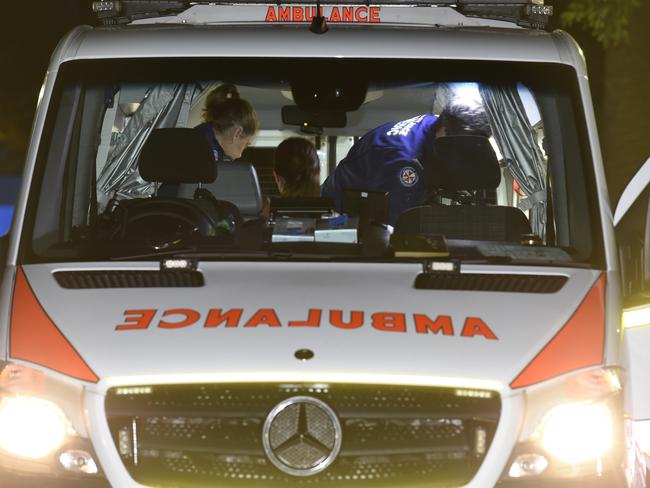 Paramedics working on a woman with a suspected drug overdose at the Field Day music festival. Picture: Gordon McComiskie