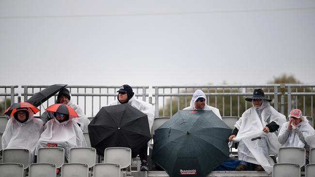 Racegoers took shelter as rain hammered the Bathurst 1000 in 2019. Picture: AAP