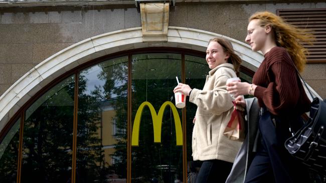 Women walk past a closed McDonald's restaurant in Moscow on May 16, 2022. The fast-food giant has joined other Western businesses pulling out of Russia. Picture: Natalia Koleniskova/AFP