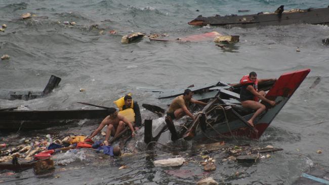 Navy personnel search for survivors after an asylum-seeker boat crashed into Christmas Island in 2010. Picture: Amy Rossbach and Allan Krepp