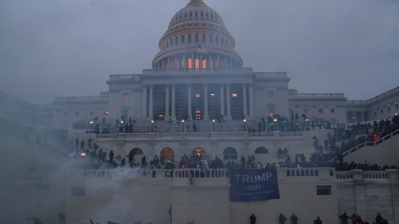 Police officers stand guard as protesters gather in front of the US Capitol Building. Picture: Leah Millis/Reuters