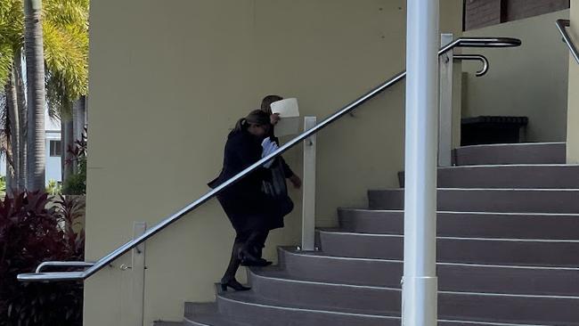 Sean Lachlan Martin tries to hide behind his lawyer as he walks into Mackay courthouse to face charges including using electronic communication to procure a child under 16, distributing child abuse material using a hidden network, indecent treatment of a child, and making and possessing child abuse material.