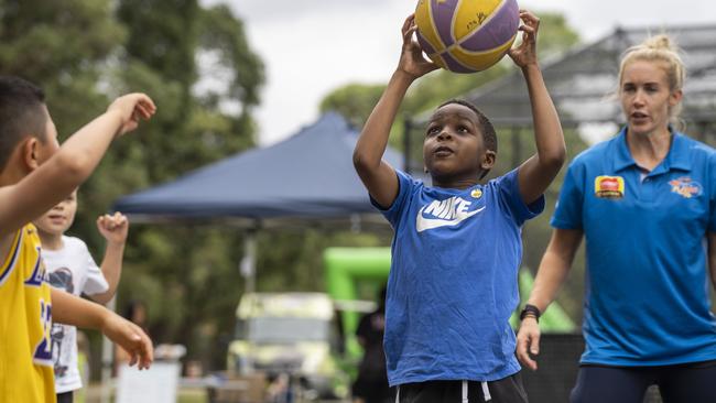 Local kids at a basketball workshop with Brittany Smart (pictured, right) Sydney Uni Flames WNBL at the new basketball courts in Morrison Bay Park in Putney. Picture: Matthew Vasilescu