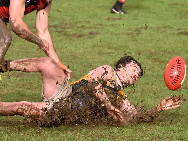 Frankston YCW's Ben Wagner slides with Frankston Bombers player Jason Kingsbury in pursuit. Picture: Rab Siddhi