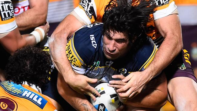 James Tamou is tackled by the Broncos defence.