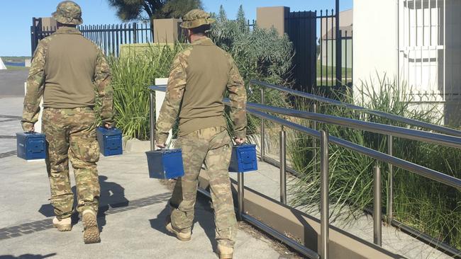 ADF personnel seizing items from the museum. Picture: Madeline Crittenden.