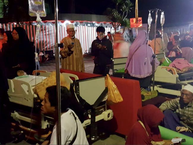 Hospital patients and relatives wait outside after being evacuated after an earthquake rocked Indonesia’s Lombok island. Picture: AFP