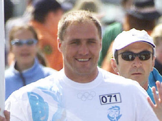 Olympic Torch Relay Day 89, Penrith to Bowral. Torchbearer footballer Tony Lockett carrying the flame on September 4, 2000.