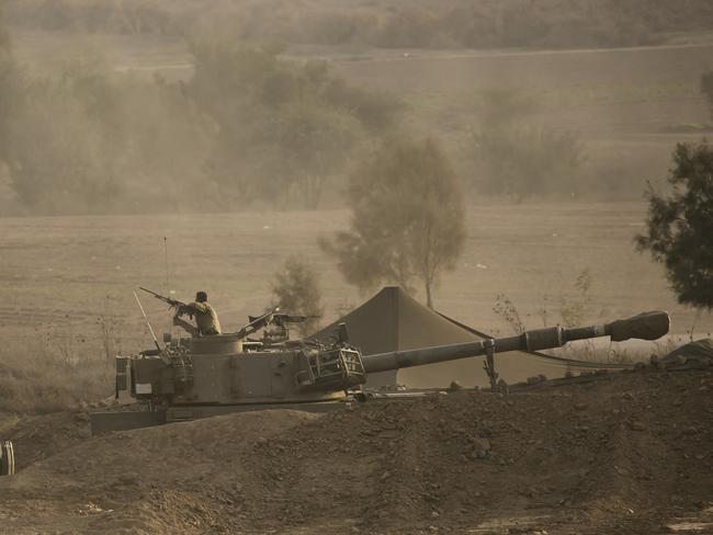 A soldier sits on an artillery unity near the Israeli border with the Gaza Strip in Netivot, Israel. Picture: Getty Images