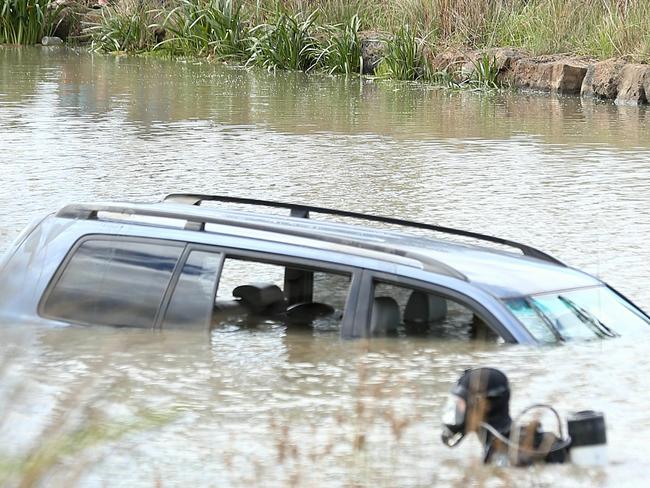 Police divers prepare to remove Akon Guode's car after it plunged into a lake off Manor Lakes Boulevarde. Picture: Mark Stewart