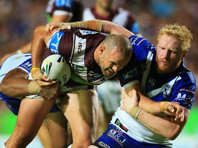 Nate Myles tackled by James Graham of the Bulldogs during the Manly Sea Eagles v Canterbury Bulldogs NRL round 1 game at Brookvale Oval. pic Mark Evans