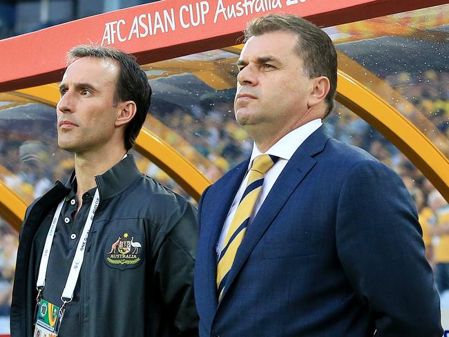 Ange Postecoglou, r, Coach of Australia, during the National Anthems at the Socceroos v Oman Asian Cup game at ANZ Stadium, Sydney Olympic Park. pic Mark Evans