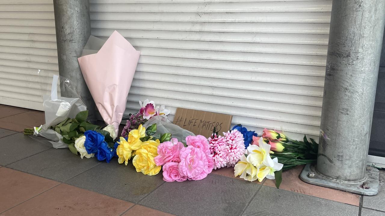 Mourners laid flowers and a sign stating #LifeMatters outside the Alice Spring Coles after being restrained by police on Wednesday May 27. Picture: Gera Kazakov