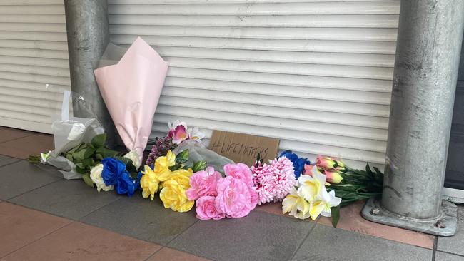 Mourners laid flowers and a sign stating #LifeMatters outside the Alice Spring Coles after being restrained by police on Wednesday May 27. Picture: Gera Kazakov