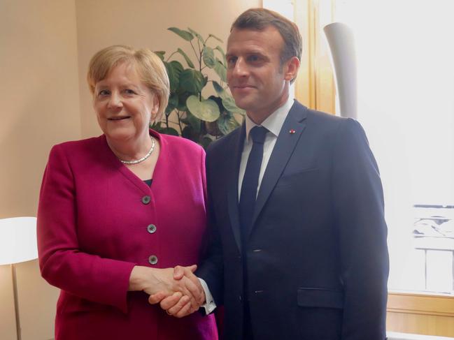 German Chancellor Angela Merkel (L) meets with French President Emmanuel Macron prior to a meeting on the sidelines of a European Union (EU) summit at EU Commission Headquarters in Brussels on May 28, 2019. (Photo by Olivier Matthys / POOL / AFP)