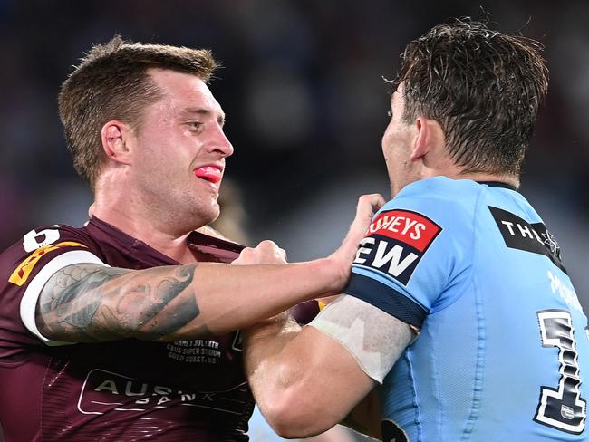 GOLD COAST, AUSTRALIA - JULY 14:  Cameron Munster of the Maroons and Angus Crichton of the Blues scuffle during game three of the 2021 State of Origin Series between the New South Wales Blues and the Queensland Maroons at Cbus Super Stadium on July 14, 2021 in Gold Coast, Australia. (Photo by Bradley Kanaris/Getty Images)