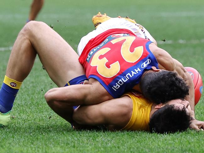 PERTH, AUSTRALIA - JULY 14: Liam Duggan of the Eagles lies concussed tackled by Charlie Cameron of the Lions during the 2024 AFL Round 18 match between the West Coast Eagles and the Brisbane Lions at Optus Stadium on July 14, 2024 in Perth, Australia. (Photo by Will Russell/AFL Photos via Getty Images)