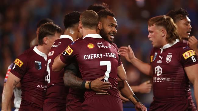 Queensland players celebrate a try during Game 3.