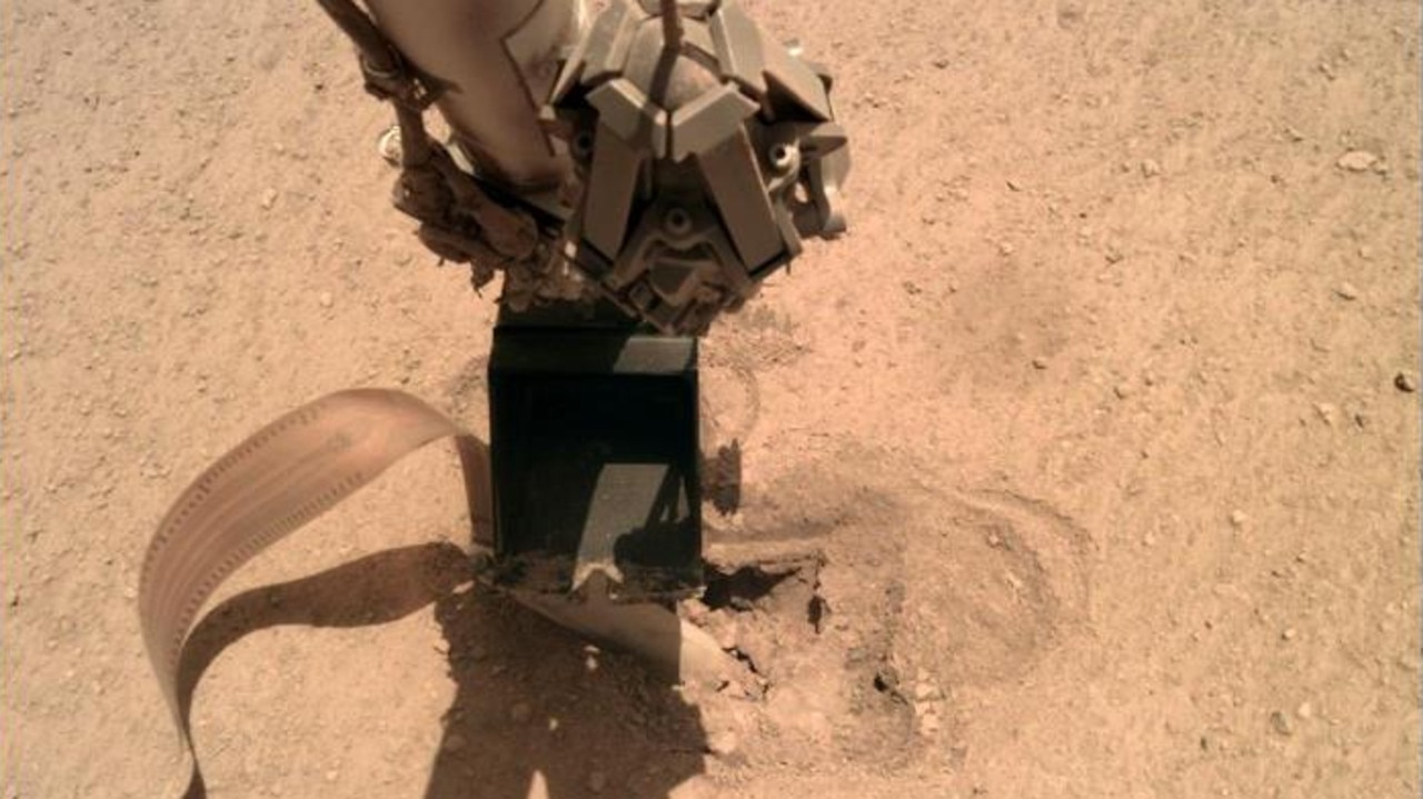 The shovel hits down on the top of the digging mole on the InSight Mars lander. Picture: NASA