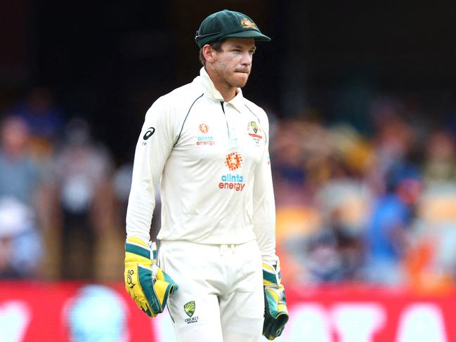 (FILES) This file photo taken on January 19, 2021 shows Australia's captain Tim Paine looking on between the overs on day five of the fourth cricket Test match between Australia and India at The Gabba in Brisbane. - Tim Paine announced his shock resignation as Australian Test cricket captain on November 19, 2021 over what he described as an inappropriate "private text exchange" with a then-colleague. (Photo by PATRICK HAMILTON / AFP) / -- IMAGE RESTRICTED TO EDITORIAL USE - STRICTLY NO COMMERCIAL USE --