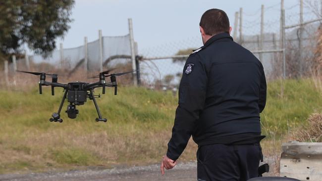 Drones were also deployed to scour the parkland. Picture: David Crosling