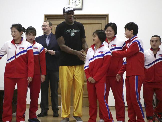 Former NBA basketball star Dennis Rodman towers over North Korean Olympic athletes in Pyongyang. Picture: AP Photo/Kim Kwang Hyon