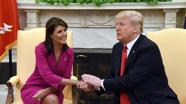 Donald Trump shakes hands with Nikki Haley. (Photo by Olivier Douliery / AFP)